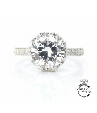 A large, clear diamond engagement ring with a halo of smaller diamonds around the center stone.