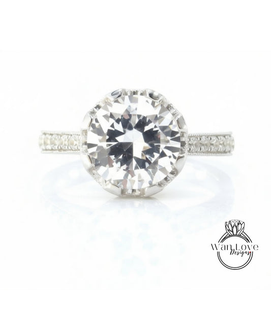 A large, clear diamond engagement ring with a halo of smaller diamonds around the center stone.