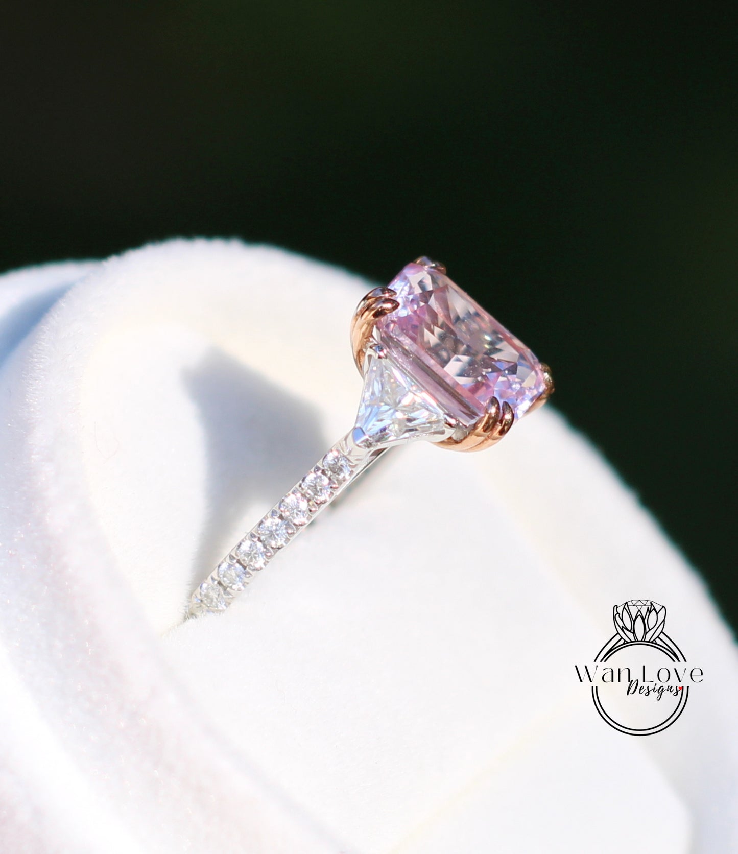 A close-up image of a diamond engagement ring with a large pink gemstone set in a silver band.