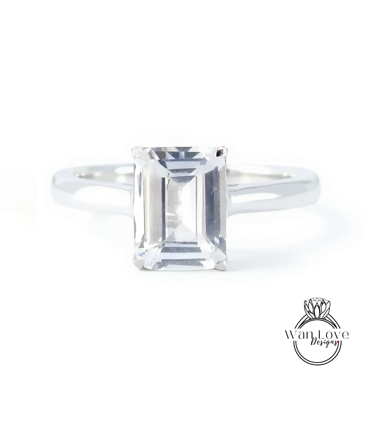 A diamond engagement ring with a large, clear gemstone set in a silver band.