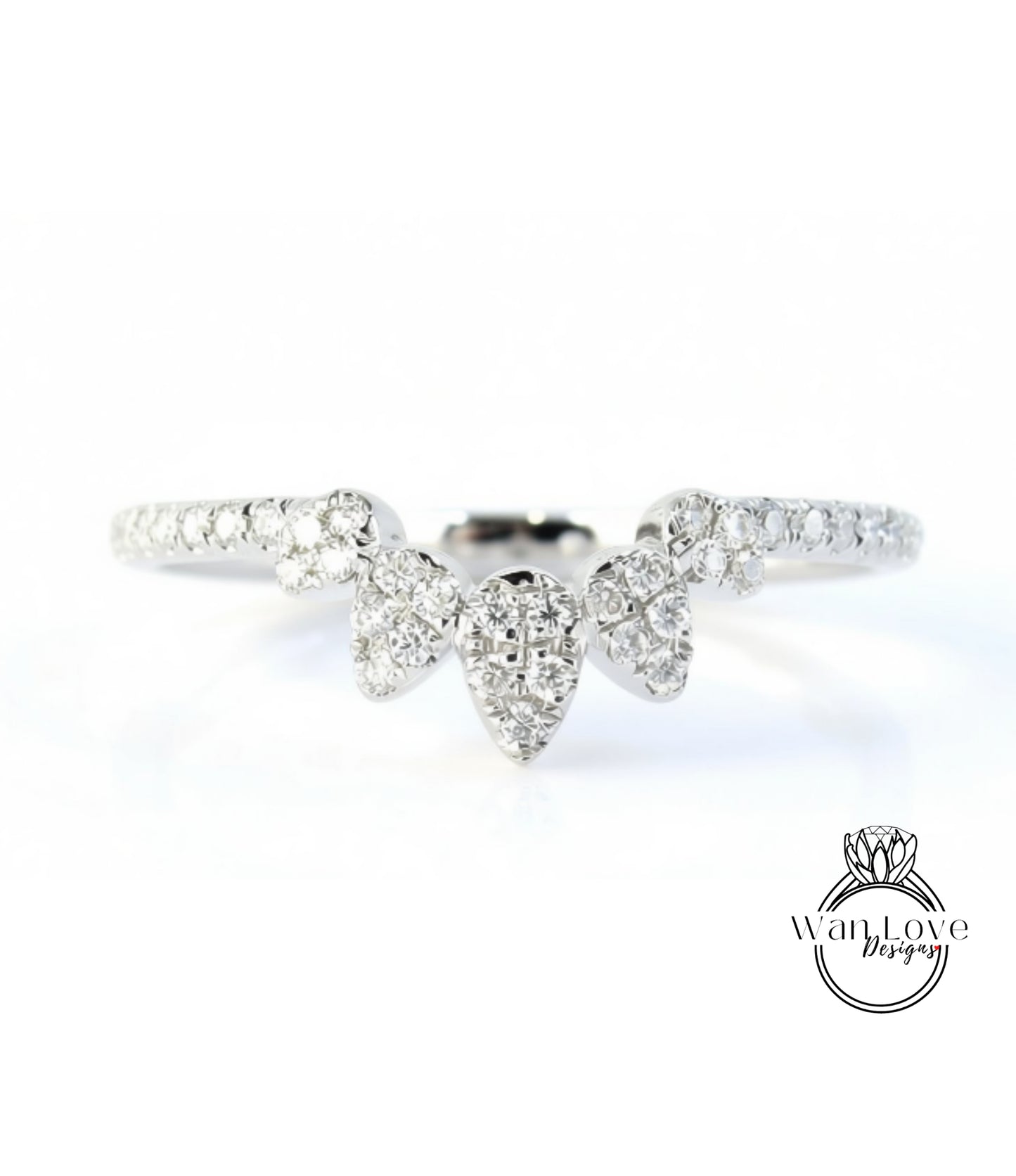 A close-up view of a diamond ring with a large central diamond surrounded by smaller diamonds, set in a silver band.