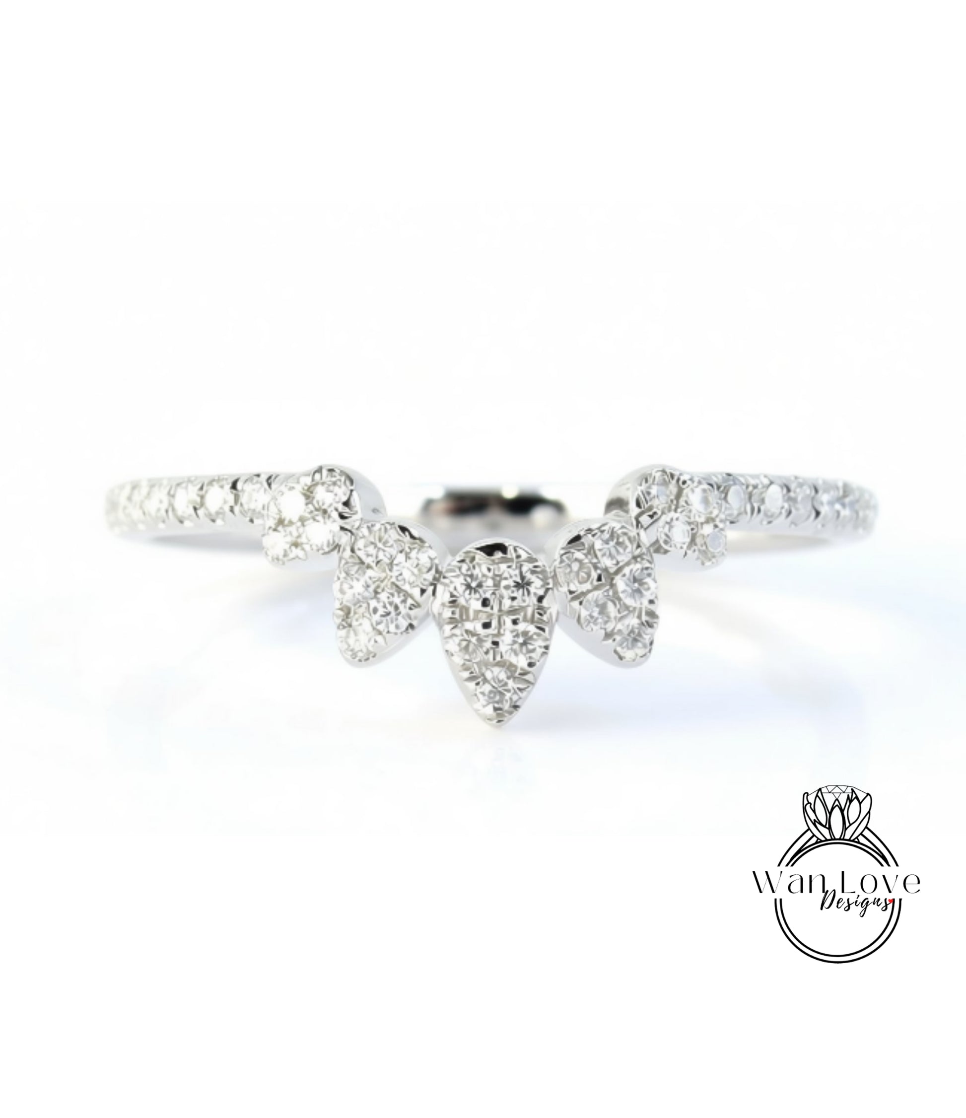 A close-up view of a diamond ring with a large central diamond surrounded by smaller diamonds, set in a silver band.