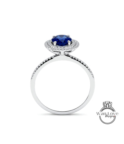 A silver ring with a large blue gemstone at the center, surrounded by smaller diamonds.
