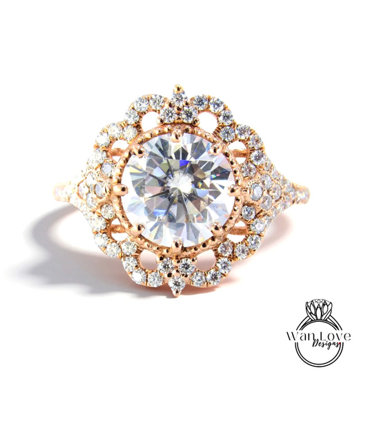A stunning diamond engagement ring with a large central diamond surrounded by smaller diamonds set in an intricate, ornate design.