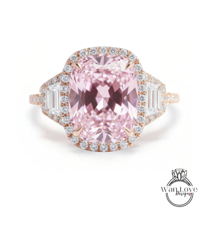 A large, pink diamond ring with a halo of smaller diamonds around the center stone.
