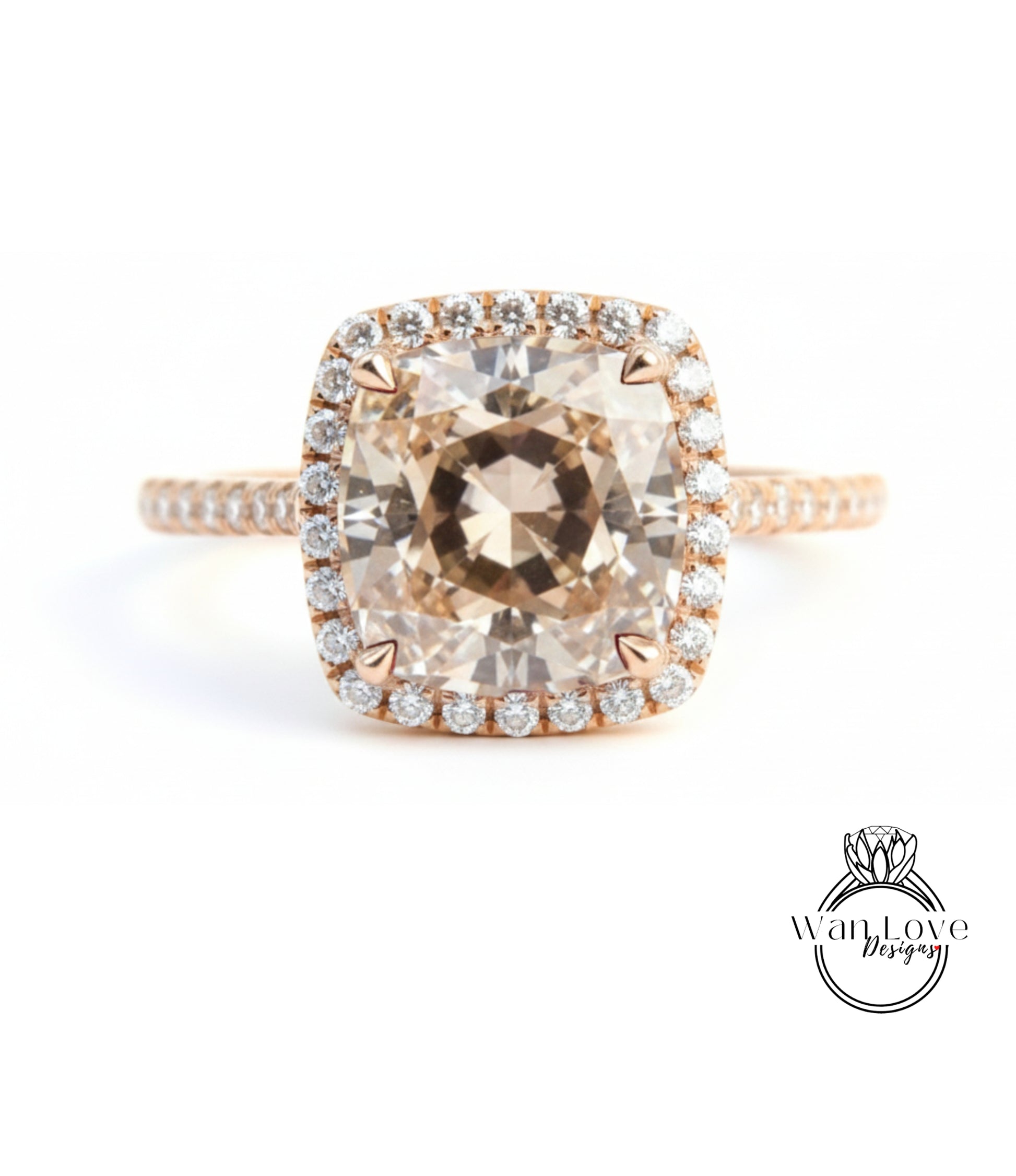 A large, round, beige diamond engagement ring with a halo of smaller diamonds around the center stone.