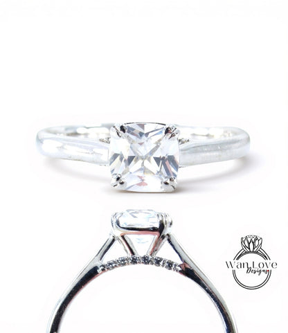 A close-up view of a diamond engagement ring with a large central diamond surrounded by smaller diamonds set in a silver band.