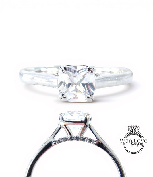 A close-up view of a diamond engagement ring with a large central diamond surrounded by smaller diamonds set in a silver band.