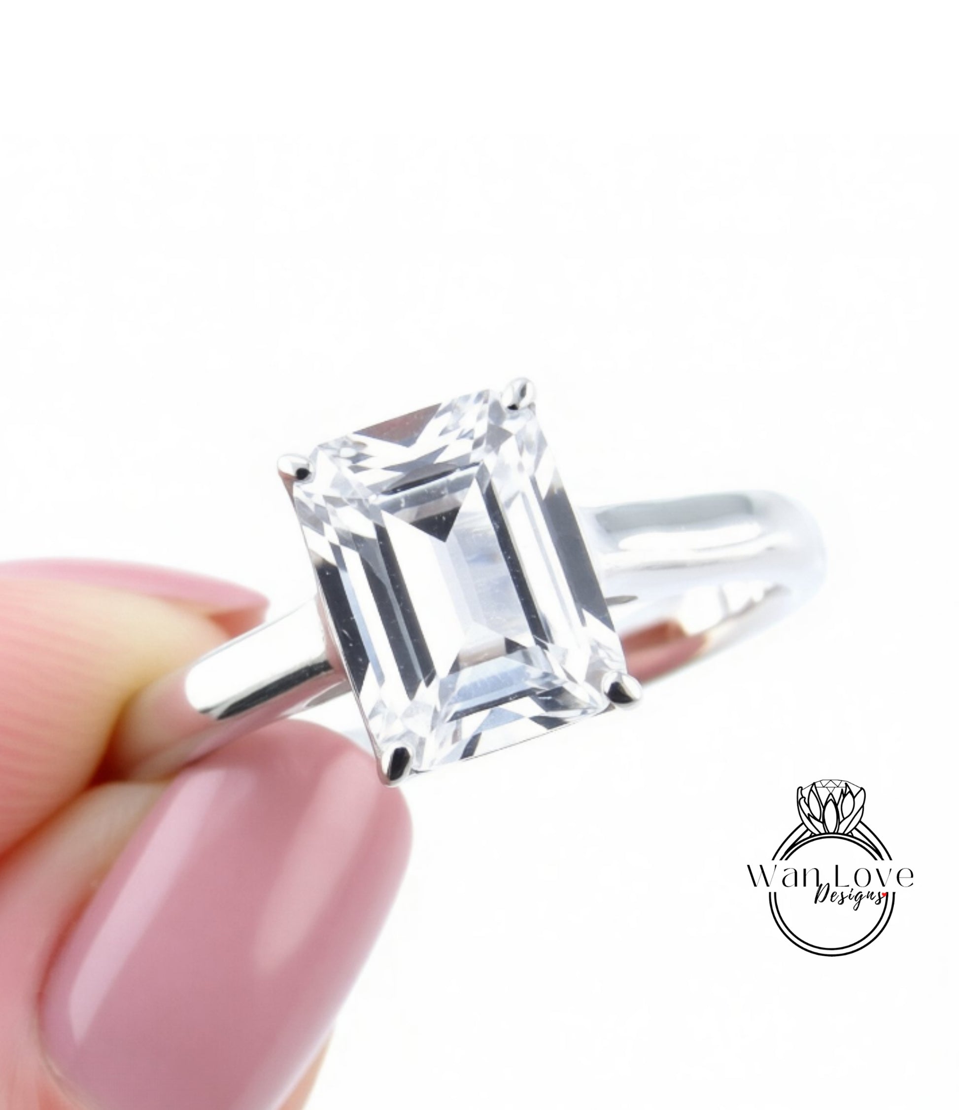 A close-up image of a person's hand holding a diamond engagement ring with a large, clear gemstone.