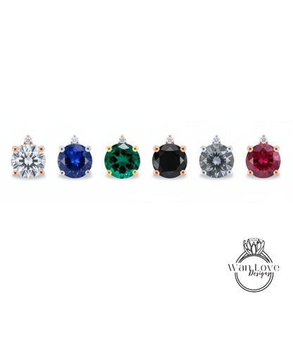 a collection of six earrings, each featuring a unique gemstone. The earrings are arranged in a row, showcasing the variety of colors and gemstones available.