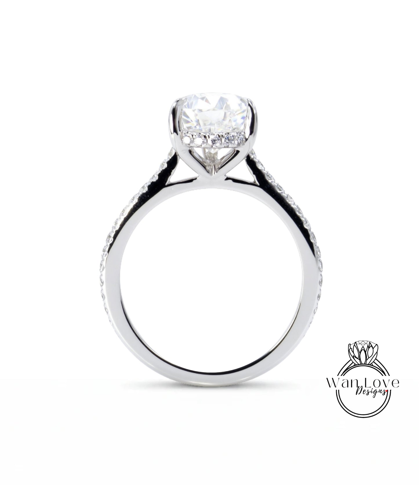 A close-up view of a silver engagement ring with a large central diamond and smaller diamonds along the band.