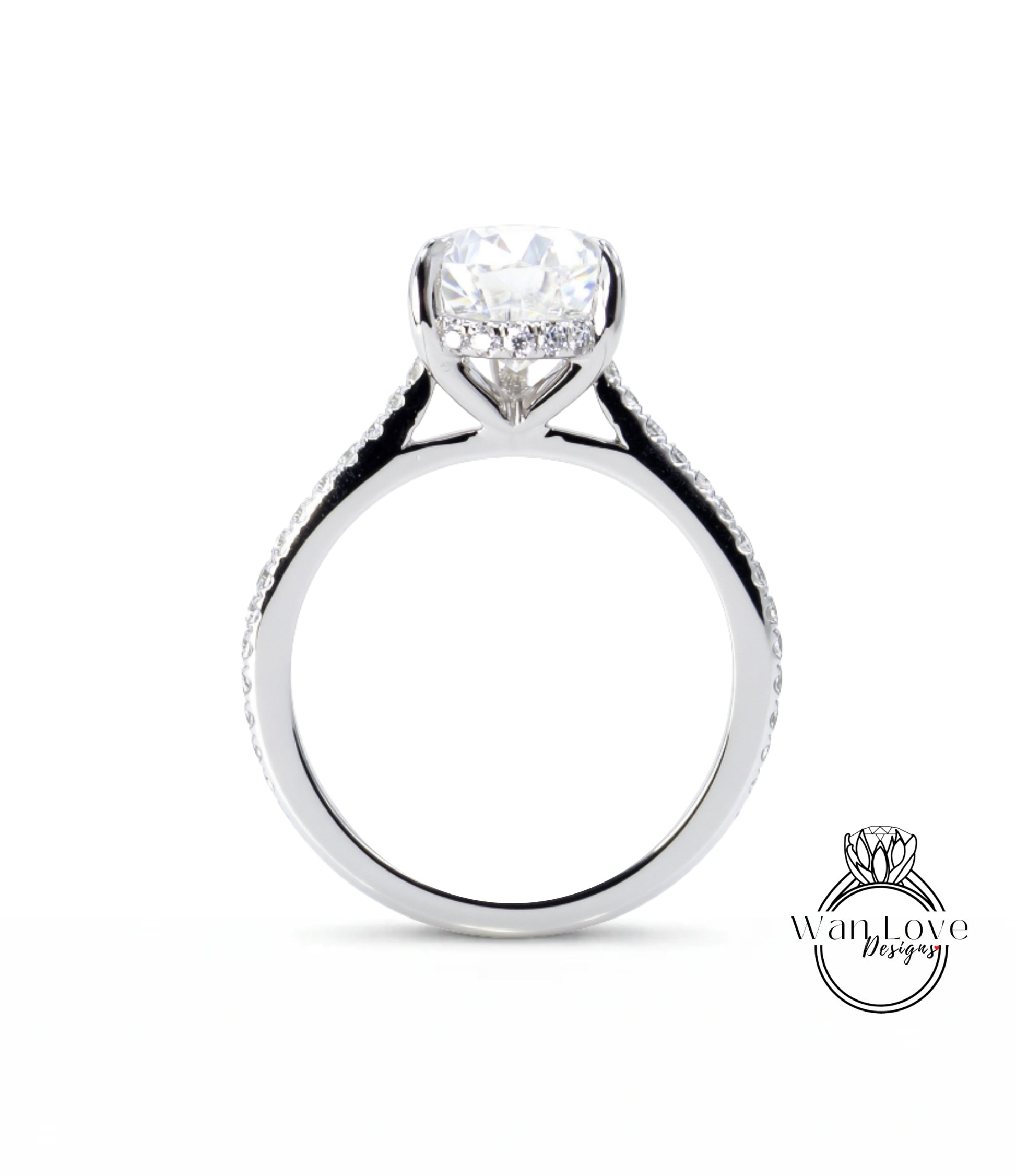 A close-up view of a silver engagement ring with a large central diamond and smaller diamonds along the band.