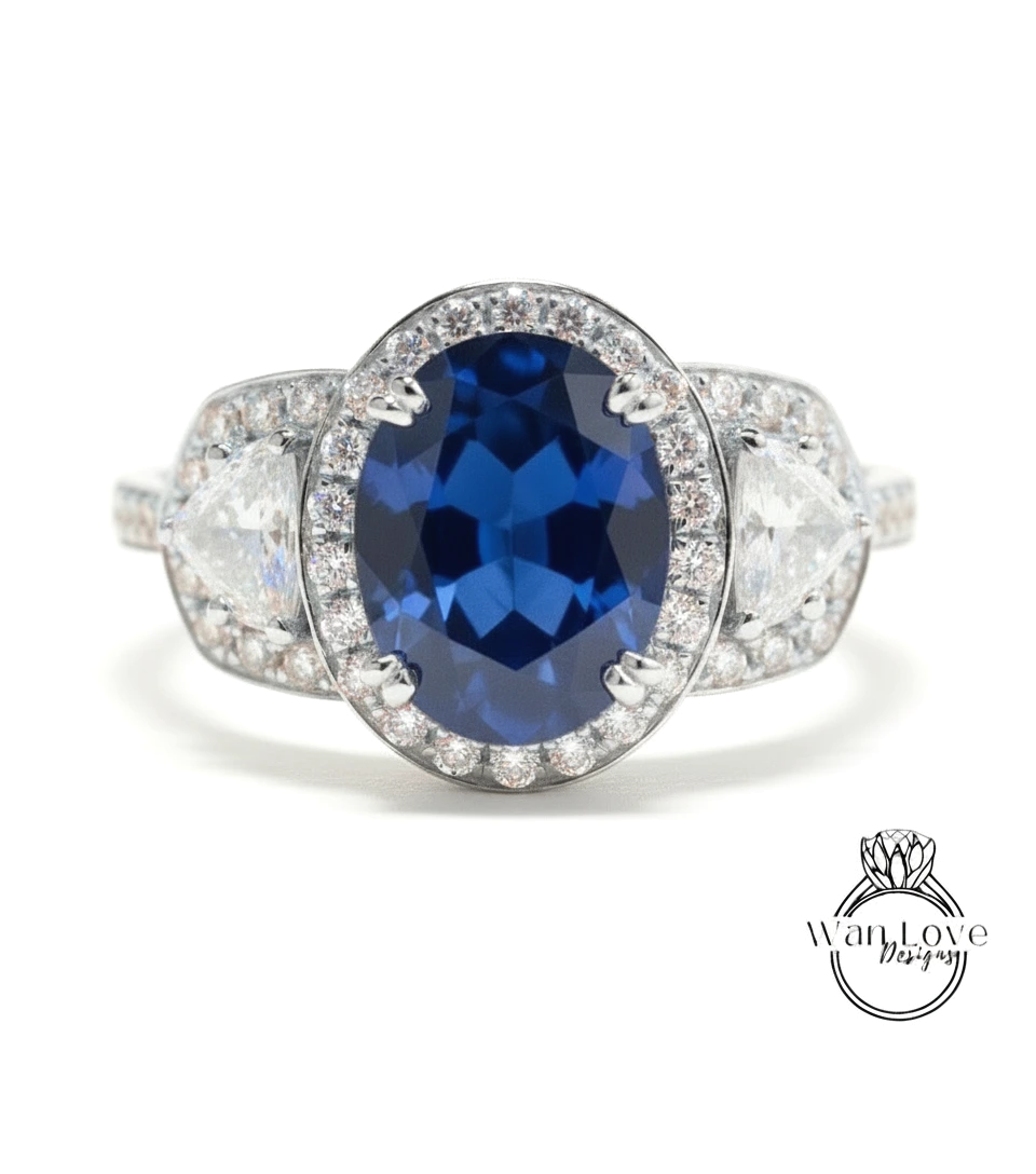 A close-up of a diamond ring with a large oval-shaped blue gemstone surrounded by smaller diamonds.