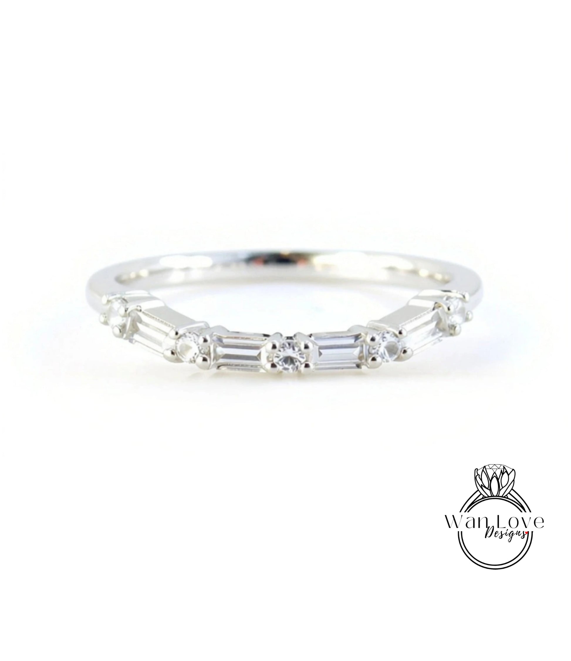 A silver ring with a row of small diamonds set in the band.