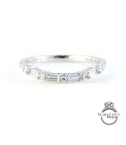 A silver ring with a row of small diamonds set in the band.