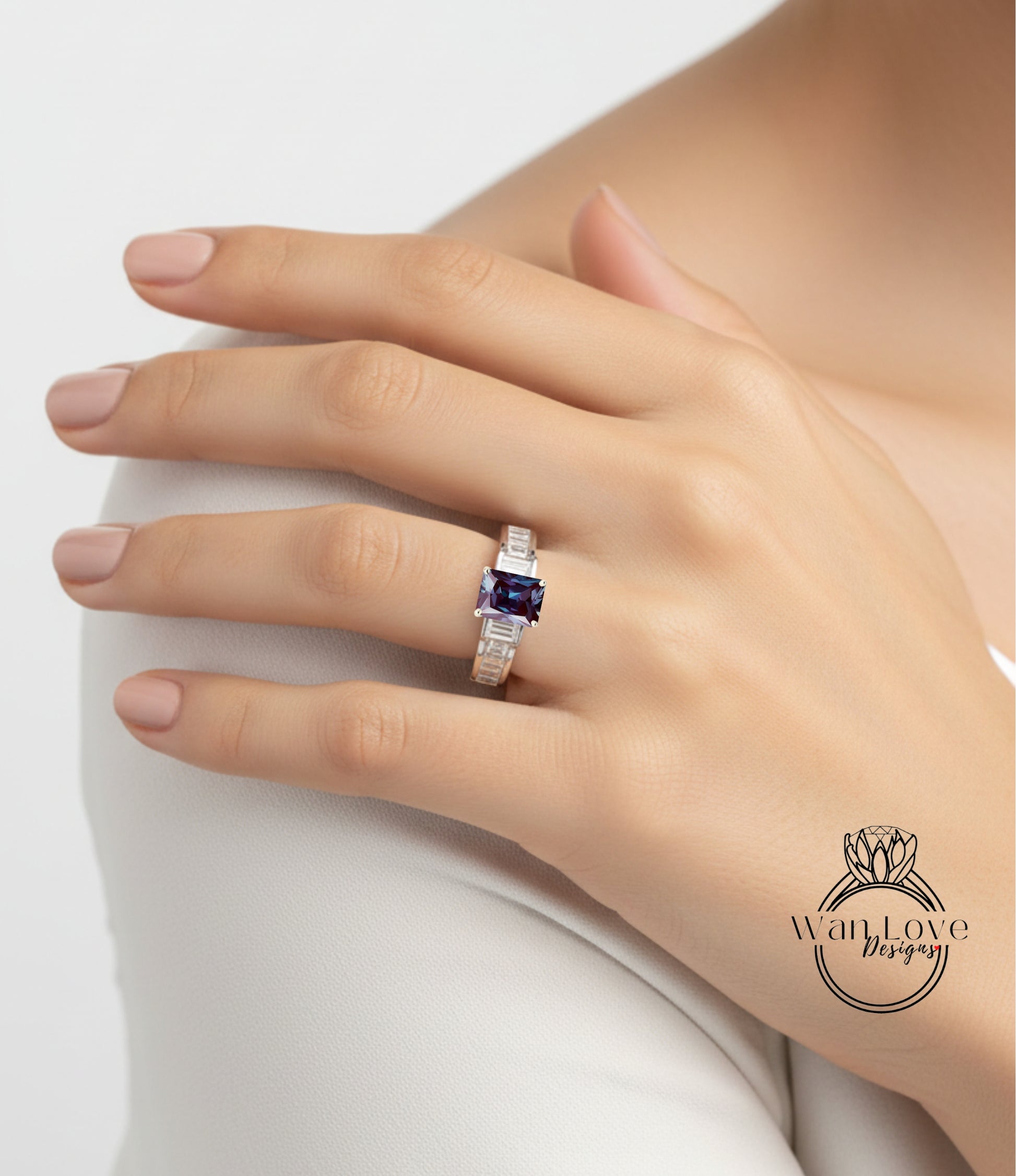 A close-up of a person's hand wearing a ring with a large purple gemstone.