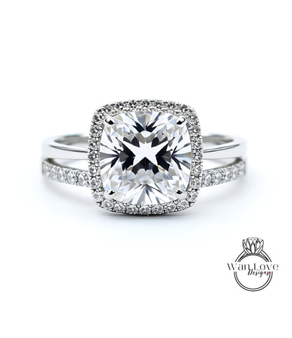 A stunning diamond engagement ring with a large, brilliant-cut diamond set in a halo of smaller diamonds, surrounded by a halo of smaller diamonds.