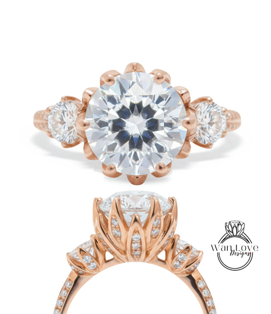 a beautiful rose gold engagement ring with a large, round diamond set in the center. The ring has three smaller diamonds on either side of the large central diamond, creating a symmetrical and elegant design.
