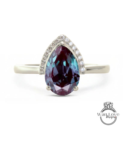 A silver ring with a large, deep purple gemstone at the center, surrounded by smaller diamonds.