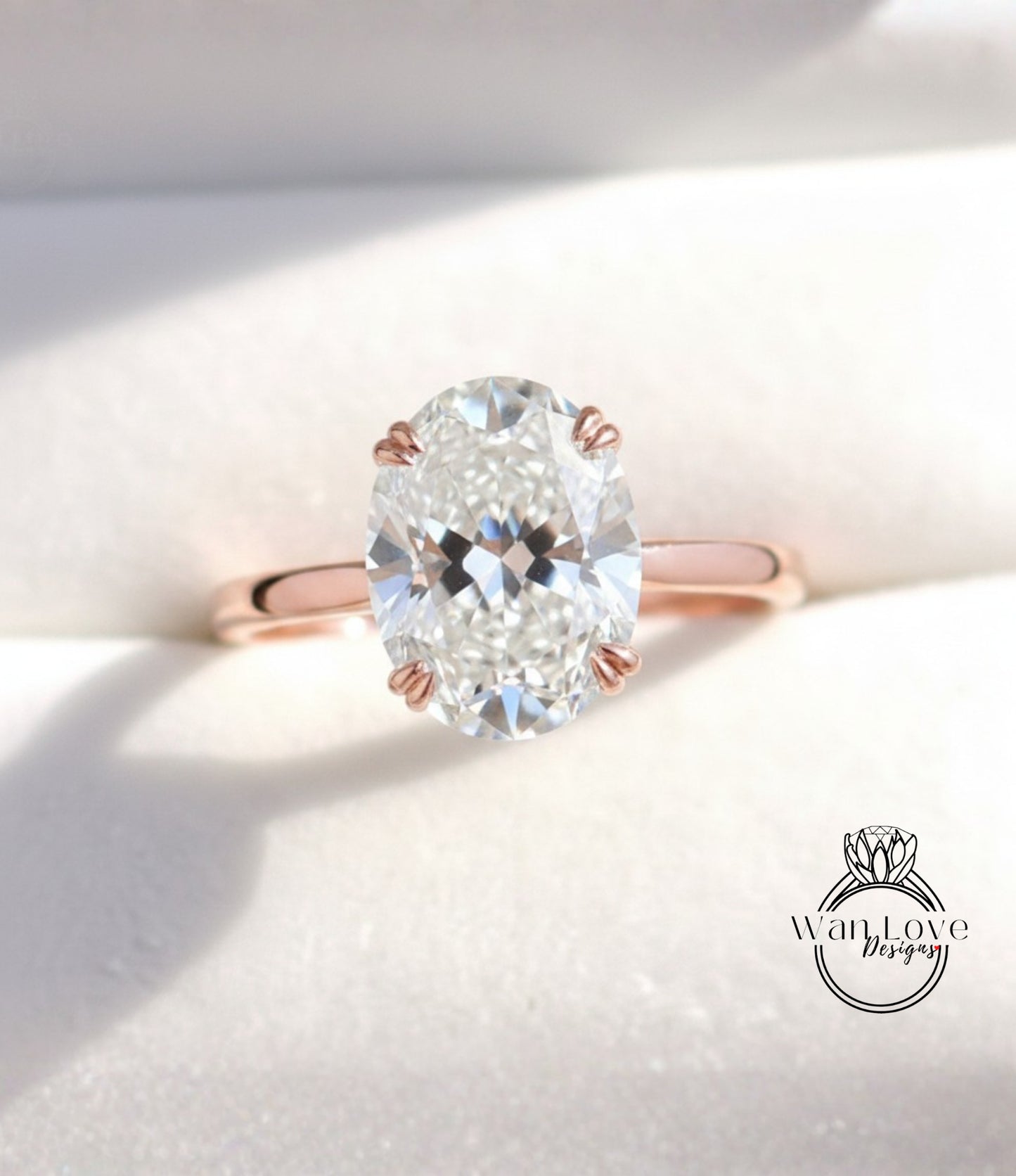 A close-up image of a diamond engagement ring with a large oval-shaped diamond set in a rose gold band.