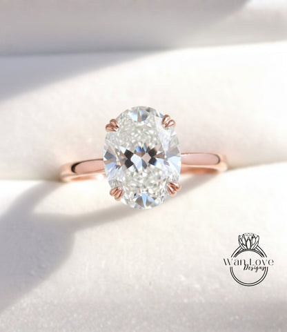 A close-up image of a diamond engagement ring with a large oval-shaped diamond set in a rose gold band.