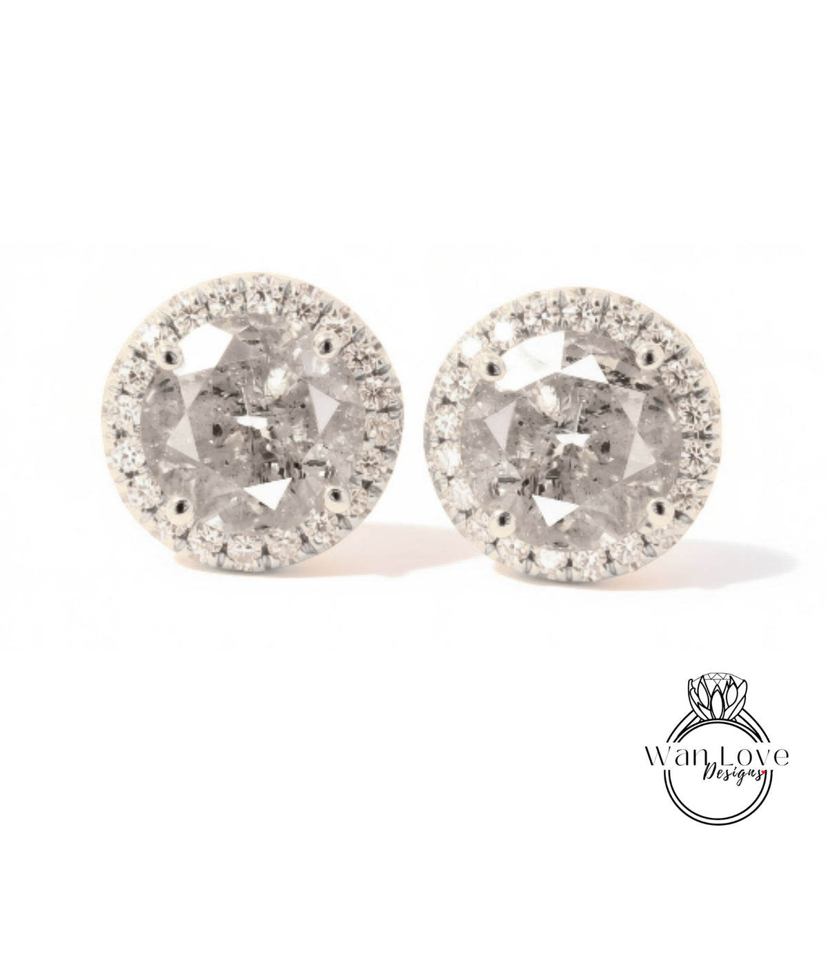 A pair of elegant earrings with a large, round diamond at the center, surrounded by smaller diamonds and set in a halo of smaller diamonds.