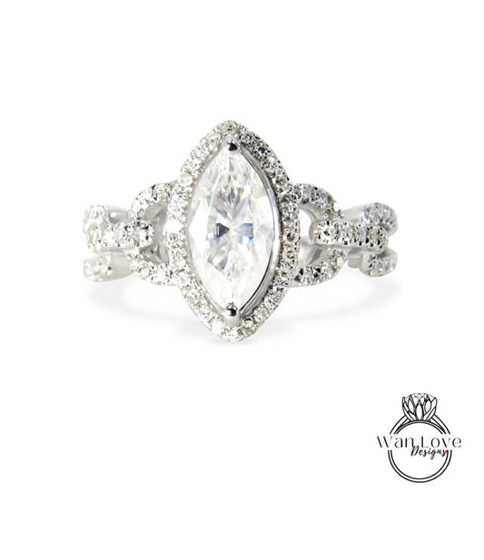 A diamond engagement ring with a large central diamond surrounded by smaller diamonds and a halo of smaller diamonds around the center stone.