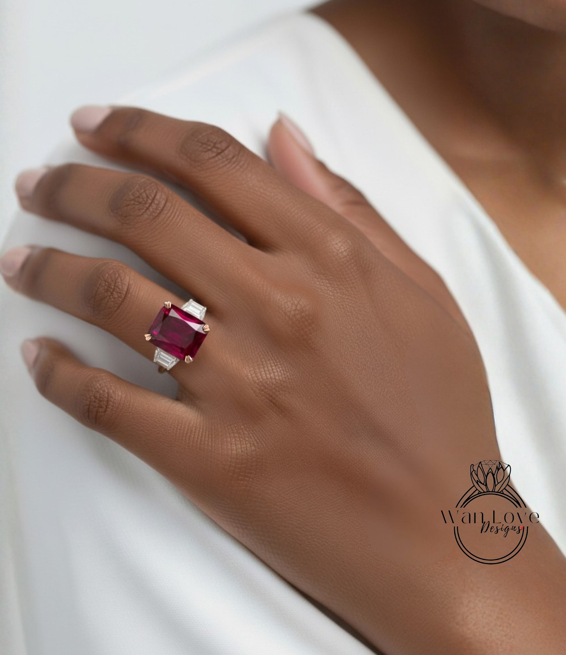 A close-up of a hand wearing a large, red gemstone ring on the ring finger.