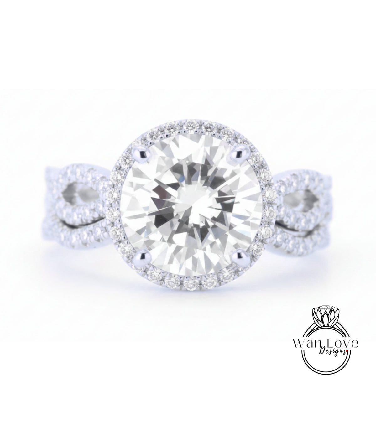 A close-up of a diamond engagement ring with a large round diamond set in a halo of smaller diamonds, surrounded by a band of smaller diamonds.