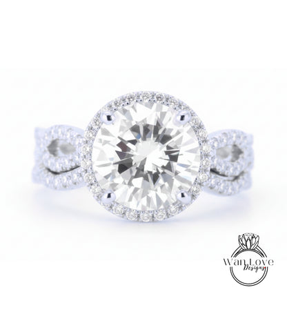 A close-up of a diamond engagement ring with a large round diamond set in a halo of smaller diamonds, surrounded by a band of smaller diamonds.