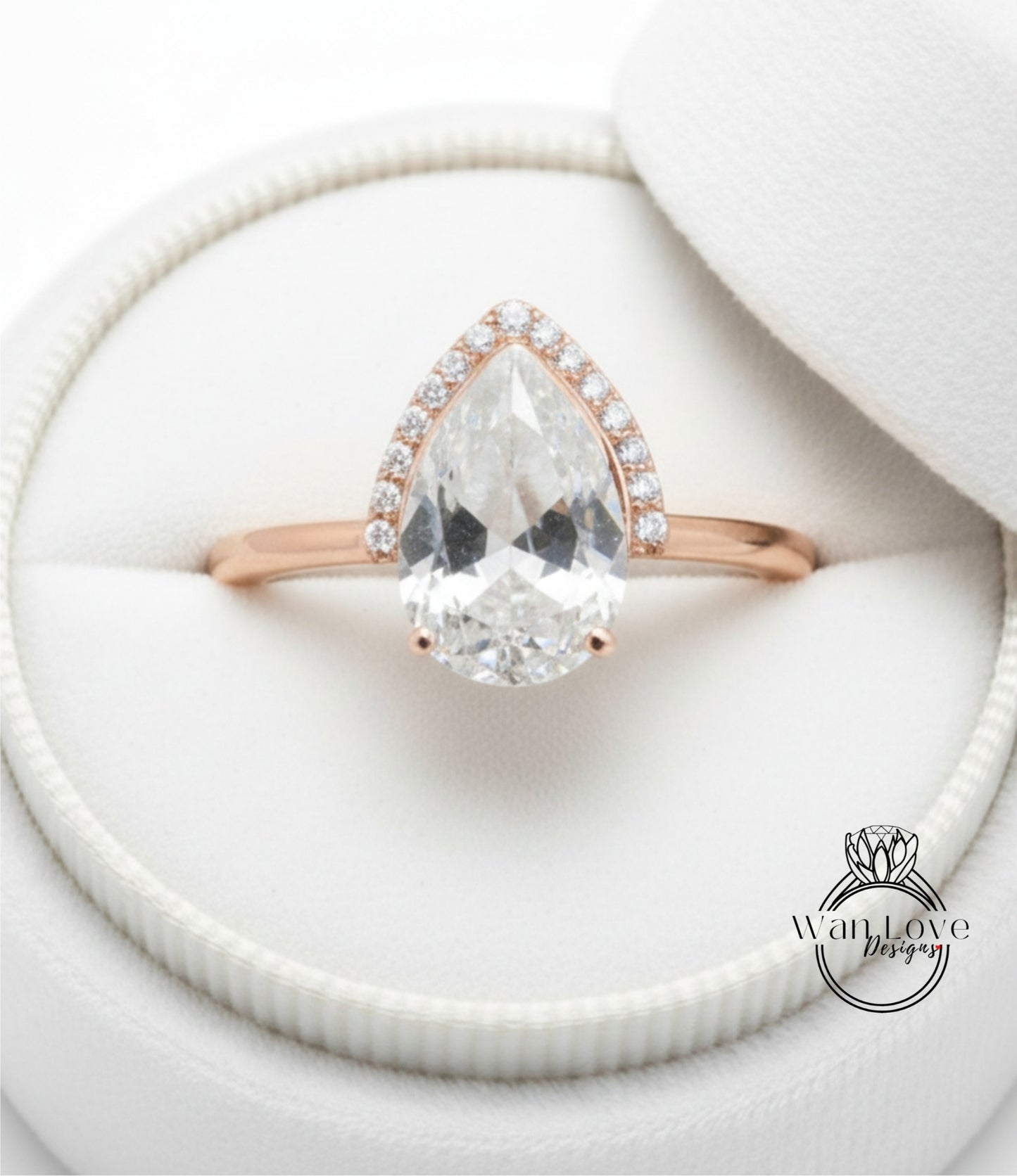 A close-up view of a diamond engagement ring placed in a white jewelry box.