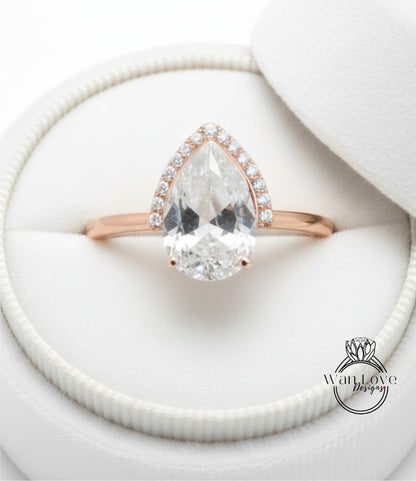 A close-up view of a diamond engagement ring placed in a white jewelry box.