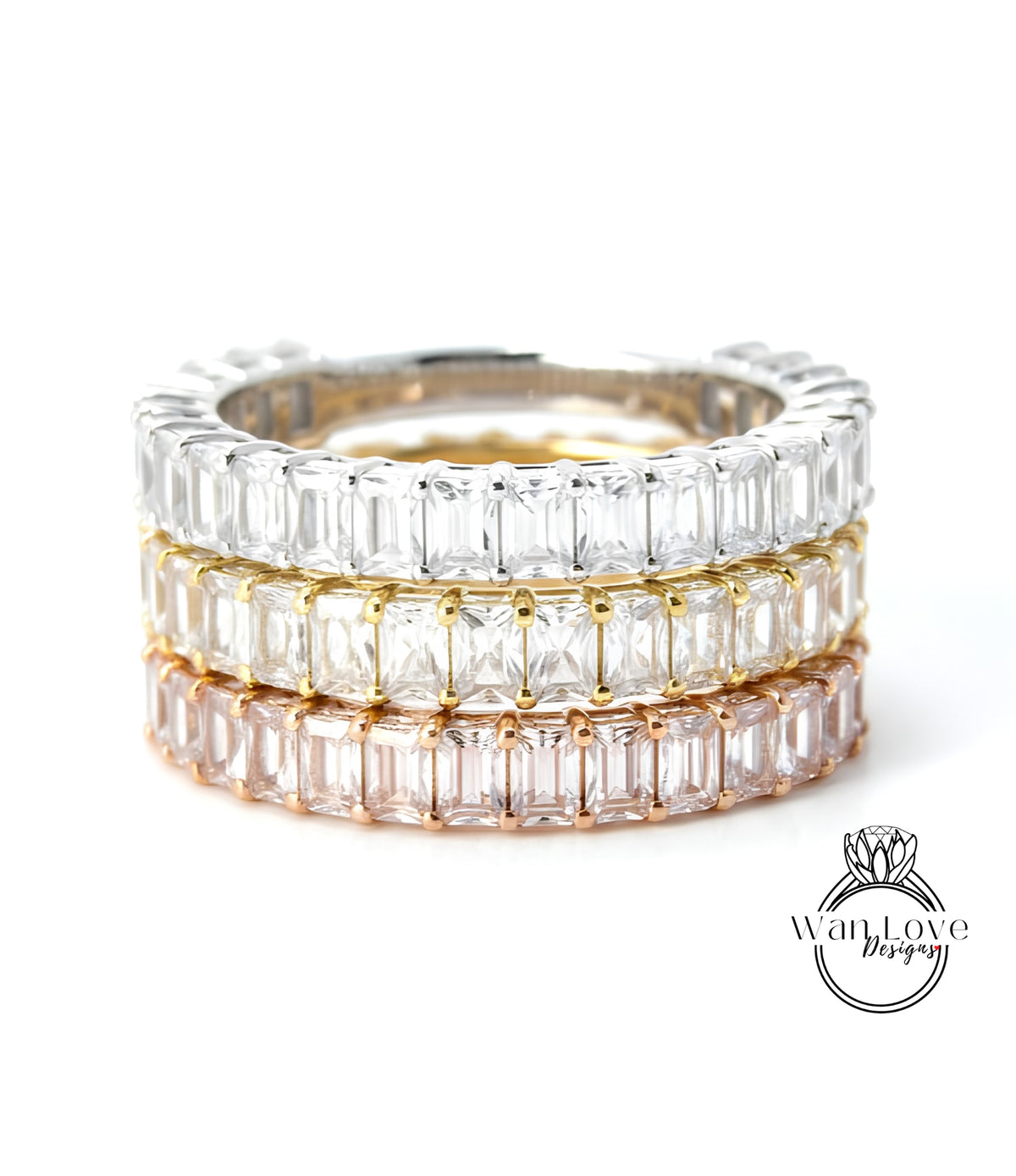 A stack of three rings, each with a row of clear gemstones, showcasing the rings in different colors.