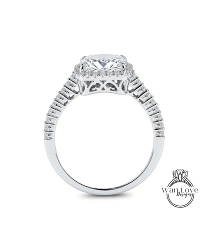 A close-up view of a diamond engagement ring with a large central diamond surrounded by smaller diamonds set in a halo.