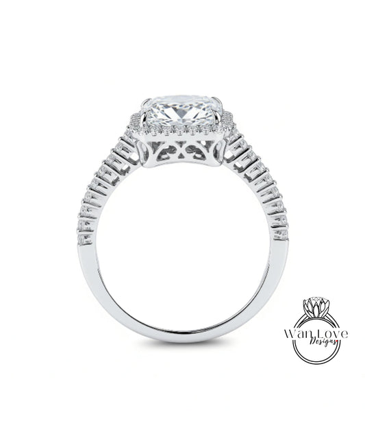 A close-up view of a diamond engagement ring with a large central diamond surrounded by smaller diamonds set in a halo.
