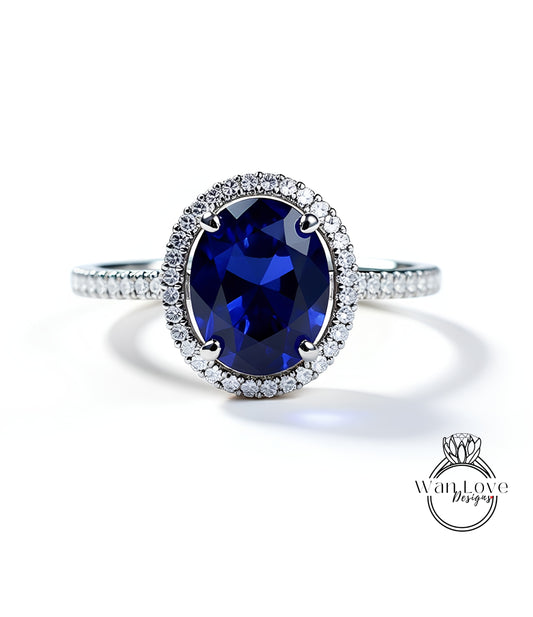 A stunning blue sapphire engagement ring with a halo of sparkling diamonds set in a silver band.