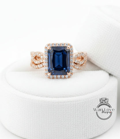 A close-up image of a gold ring with a large blue gemstone, placed on a white cloth.