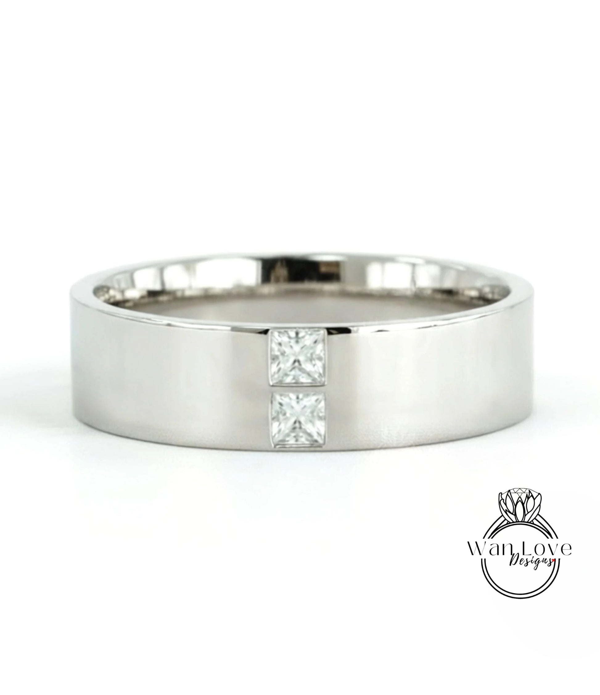 A silver-colored ring with a large diamond set in the center.