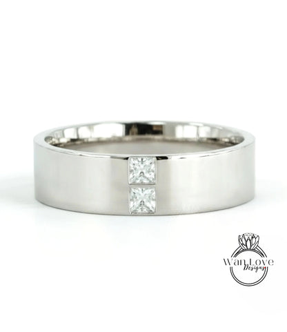 A silver-colored ring with a large diamond set in the center.