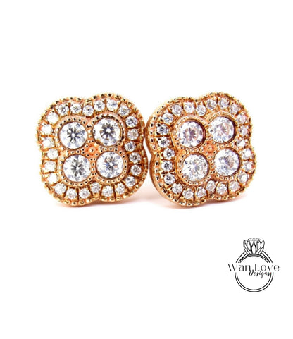 a pair of gold earrings with a large, intricate design of diamonds set in the center.