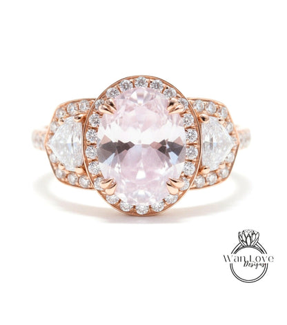 A close-up of a beautiful pink gemstone ring with a large oval-shaped gemstone surrounded by smaller diamonds.