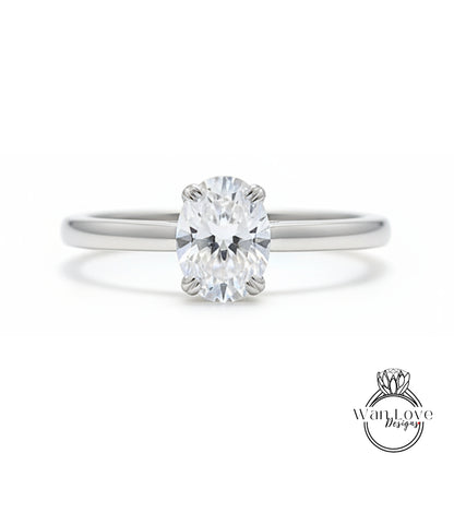 A close-up view of a diamond engagement ring with a large oval-shaped diamond set in a silver band.