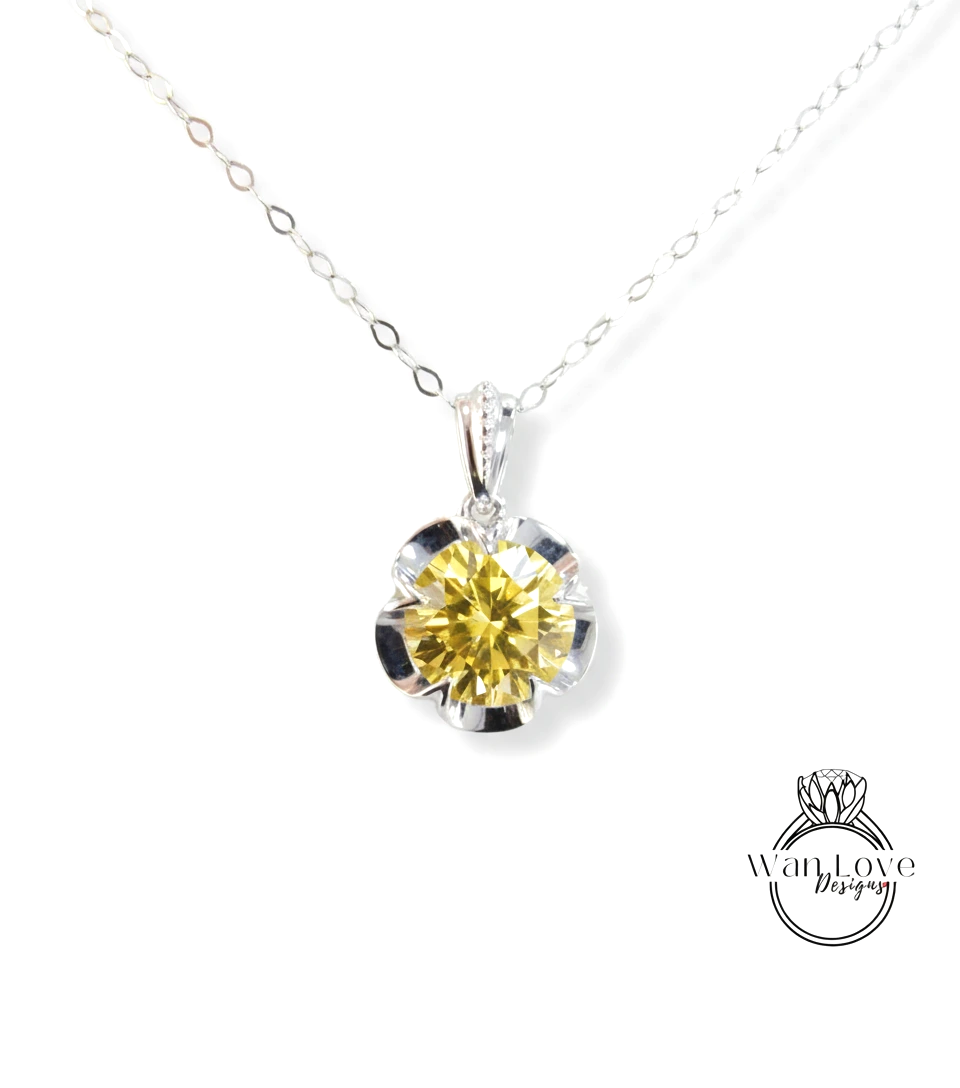 A necklace with a large yellow diamond pendant.