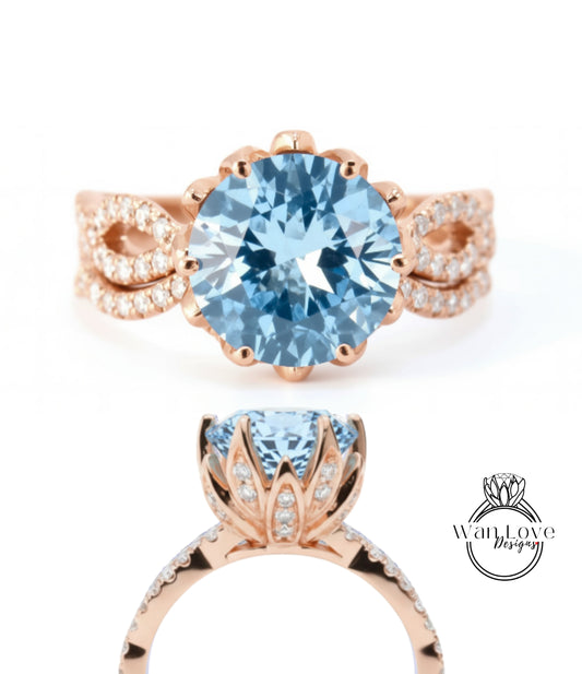 a beautiful blue gemstone ring with a large central blue gemstone surrounded by smaller diamonds set in a rose gold band.