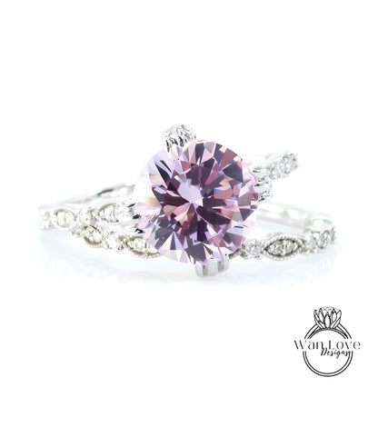 A close-up image of a beautiful pink diamond ring with a large central diamond surrounded by smaller diamonds and a delicate band.