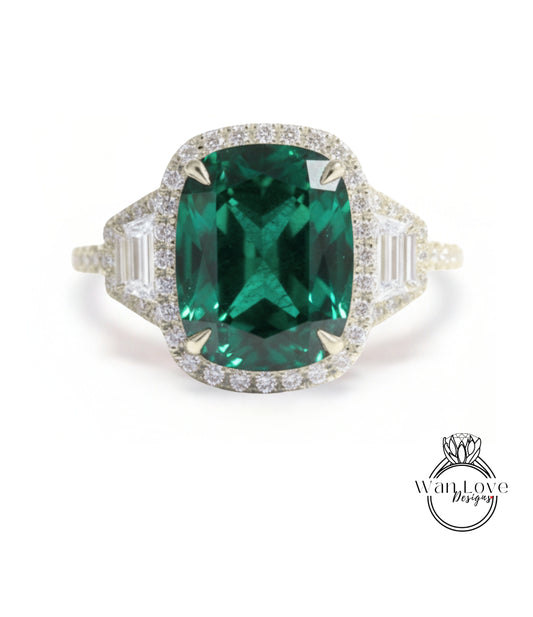 A large, oval-shaped green gemstone set in a halo of smaller diamonds, surrounded by a halo of smaller diamonds, all set in a gold ring.