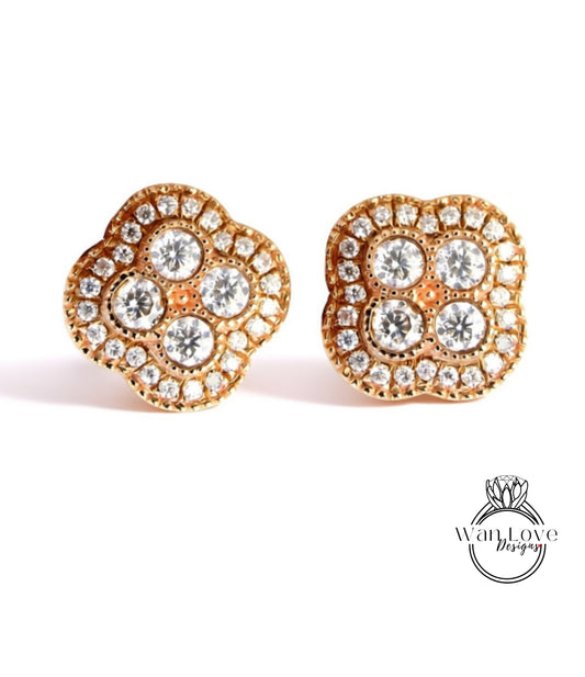 A pair of gold earrings with a large, intricate design of small diamonds set in the center.