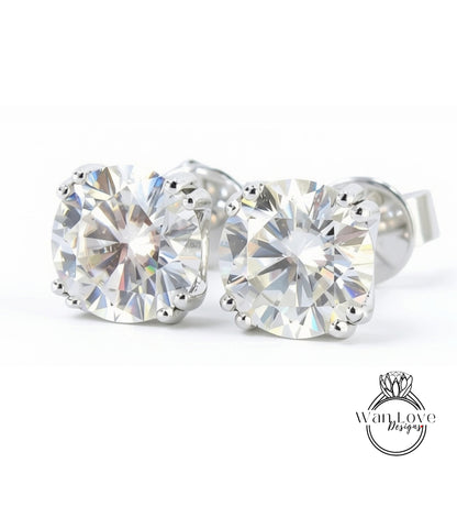 A pair of elegant diamond earrings with large, brilliant-cut diamonds set in a silver metal frame.