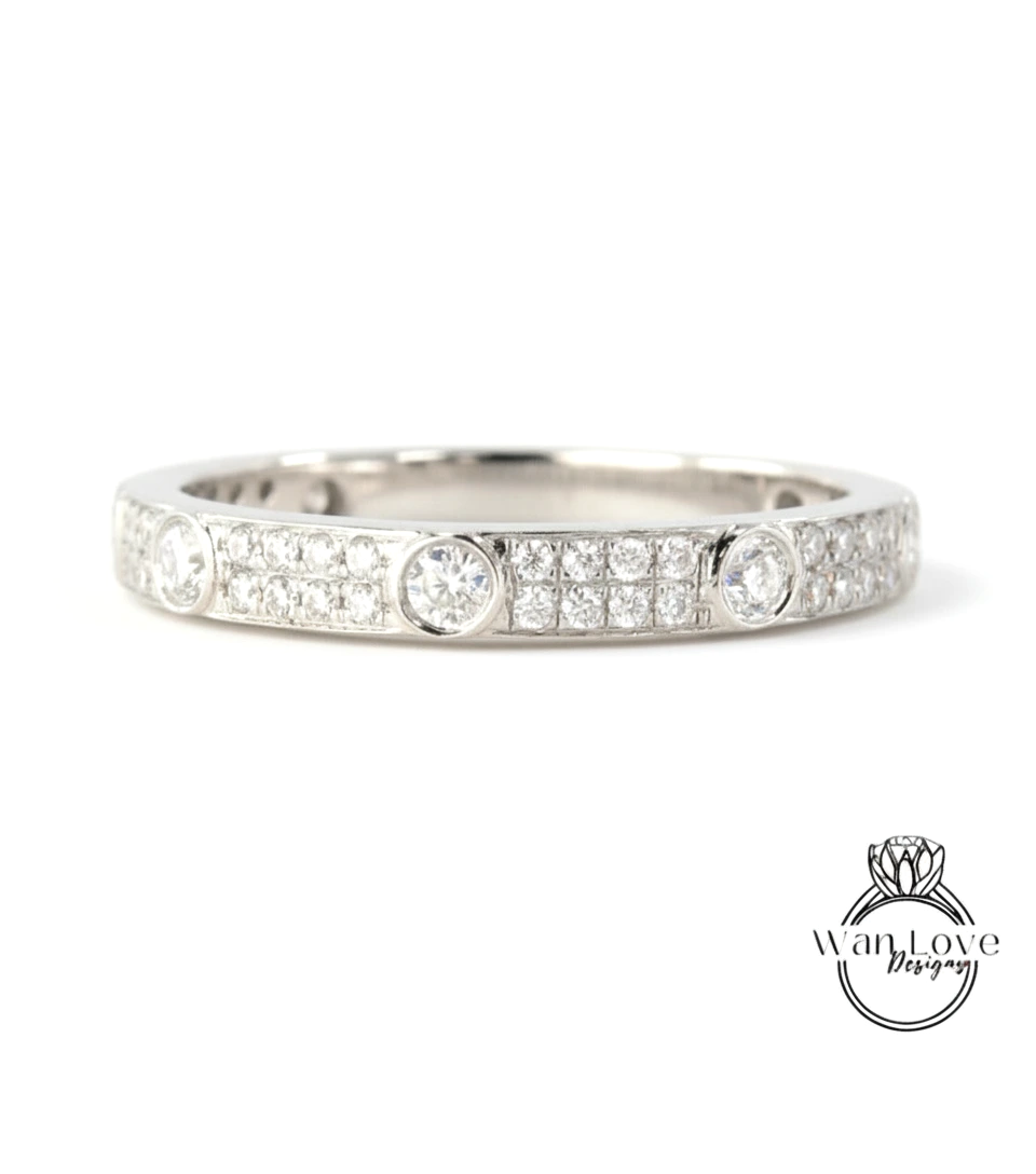 A silver band ring with a row of small diamonds set in the center.