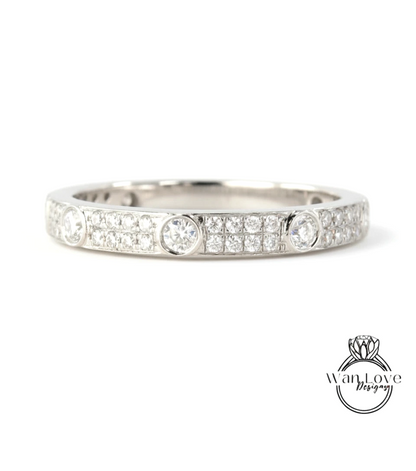 A silver band ring with a row of small diamonds set in the center.